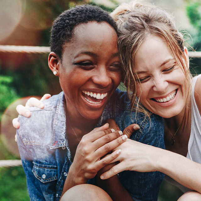 Cheerful girls embracing each other